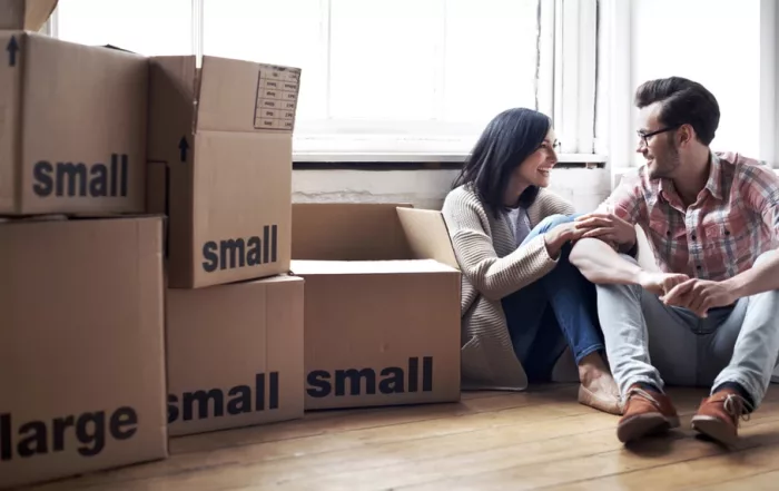 Happy couple in new home with moving boxes