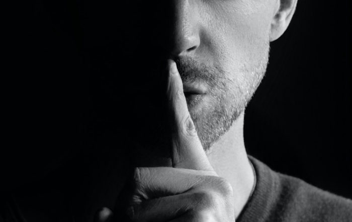 Man giving quiet sign with his finger